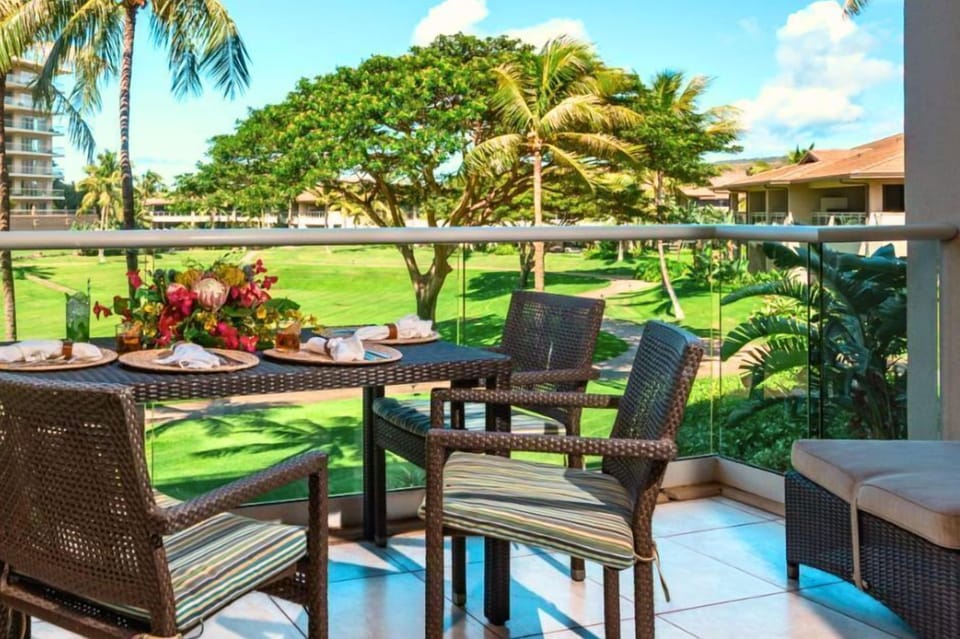 Private lanai with lush garden views and a dining table perfect for morning coffee or open-air meals. HKH-240