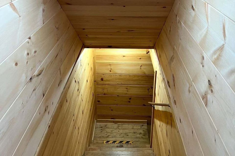 Interior stairwell connecting the three levels of Mountain Paradise log cabin in Wears Valley, Tennessee