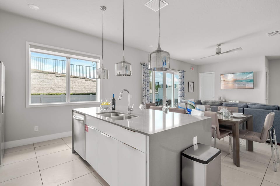 Modern kitchen island with pendant lighting and open living area for family gatherings