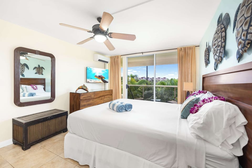 Relax in the airy, wide second bedroom—ample space to unwind, a TV for entertainment, and an easy access to the balcony, framing serene nature views on calmer days.