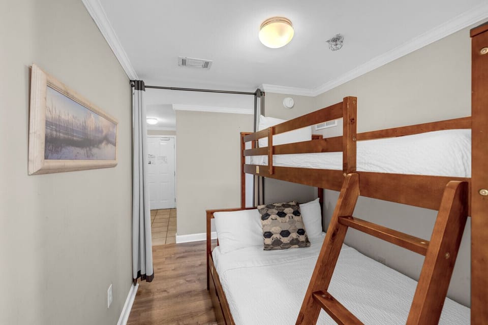 Built-in bunk bedroom with twin-over-full beds and privacy curtain—perfect for kids or extra guests.