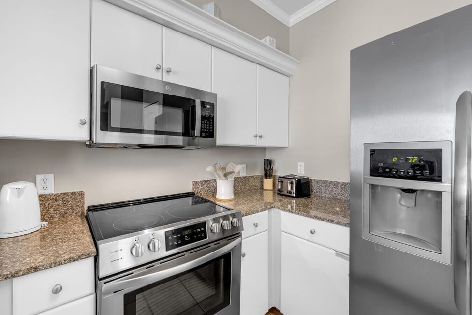 Fully equipped kitchen with stainless steel appliances and everything needed for easy vacation dining.