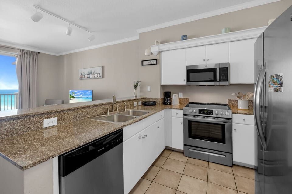Modern kitchen with granite countertops, coffee maker, and full-size appliances for your stay.