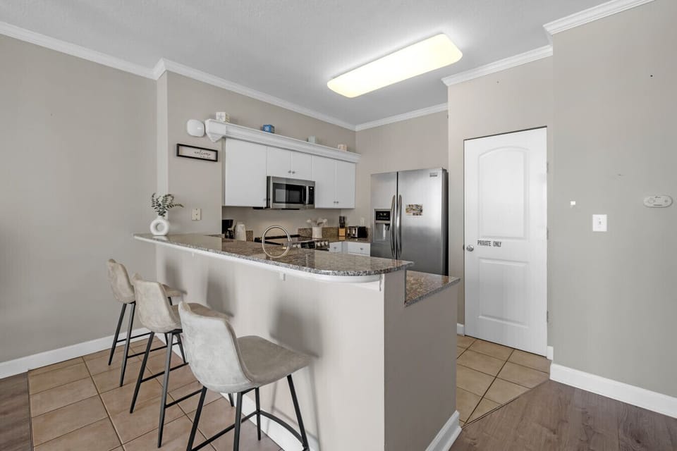 Spacious kitchen with breakfast bar seating—perfect for casual meals or morning coffee.