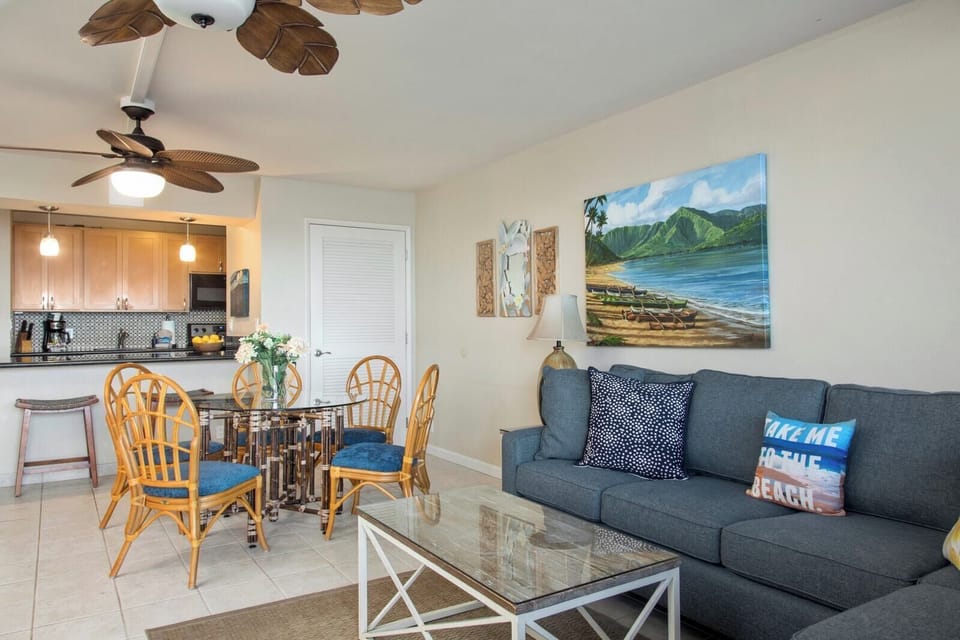 Relax in the living room where palm-leaf fans, plush seating, and coastal charm create the ultimate beachy vibe    VIR-508