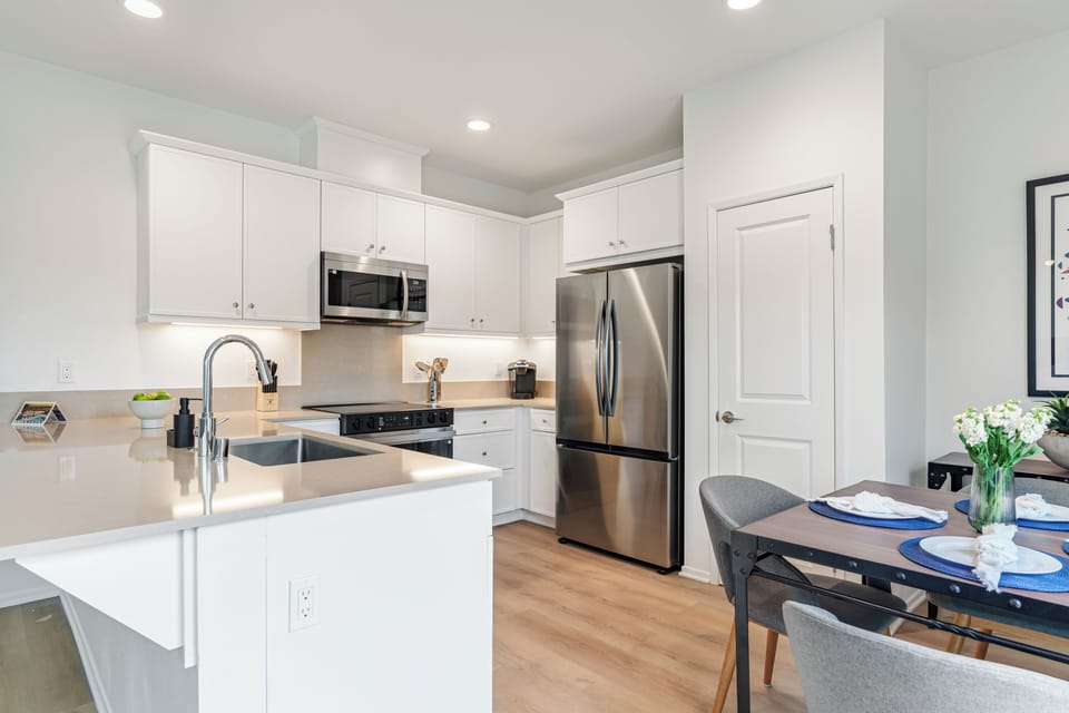 Elegant shaker-style cabinetry and sleek countertops offer both beauty and functionality.