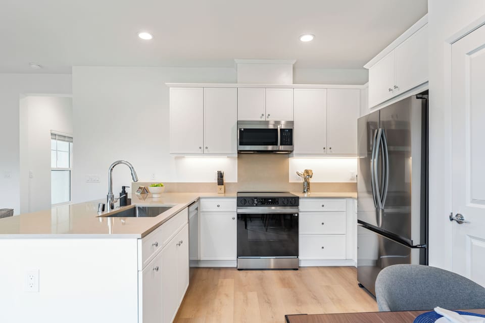 A bright and modern culinary space perfect for preparing group breakfasts or midnight snacks.