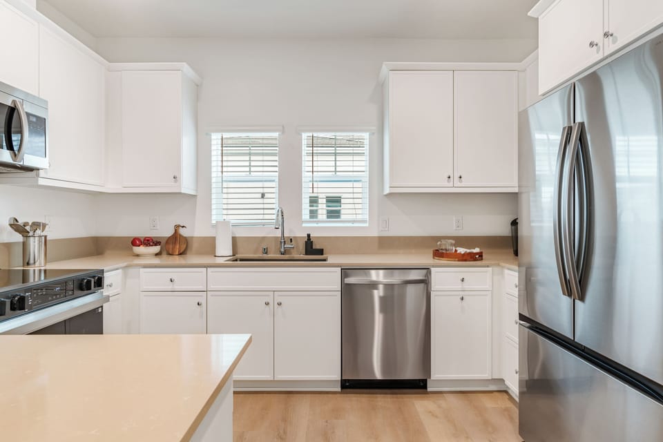 A gourmet kitchen featuring sleek shaker-style cabinetry and stainless steel appliances.
