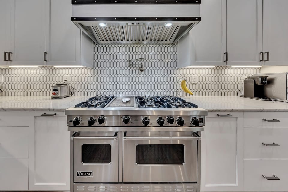Chef-style range w/ tiled backsplash & double ovens, ready for home-cooked meals