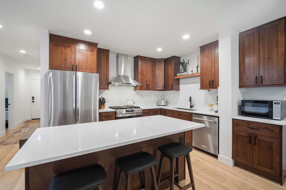 Savor your morning coffee at the spacious island while you plan your day in this fully-equipped kitchen with stainless appliances.