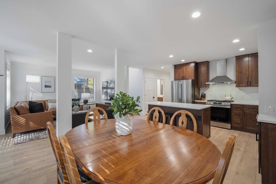 Your open-concept living features rich walnut cabinets and gleaming countertops, perfect for cooking while chatting with loved ones around the handcrafted dining table.