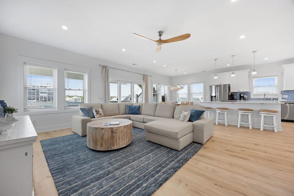 Unwind in your bright, open living space with plush sectional seating, modern kitchen, and coastal-inspired décor that creates the perfect relaxation retreat.