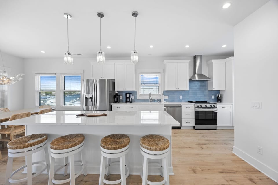 Your dream kitchen awaits with gleaming white cabinets, modern appliances, and a spacious island perfect for morning coffee or evening conversations.