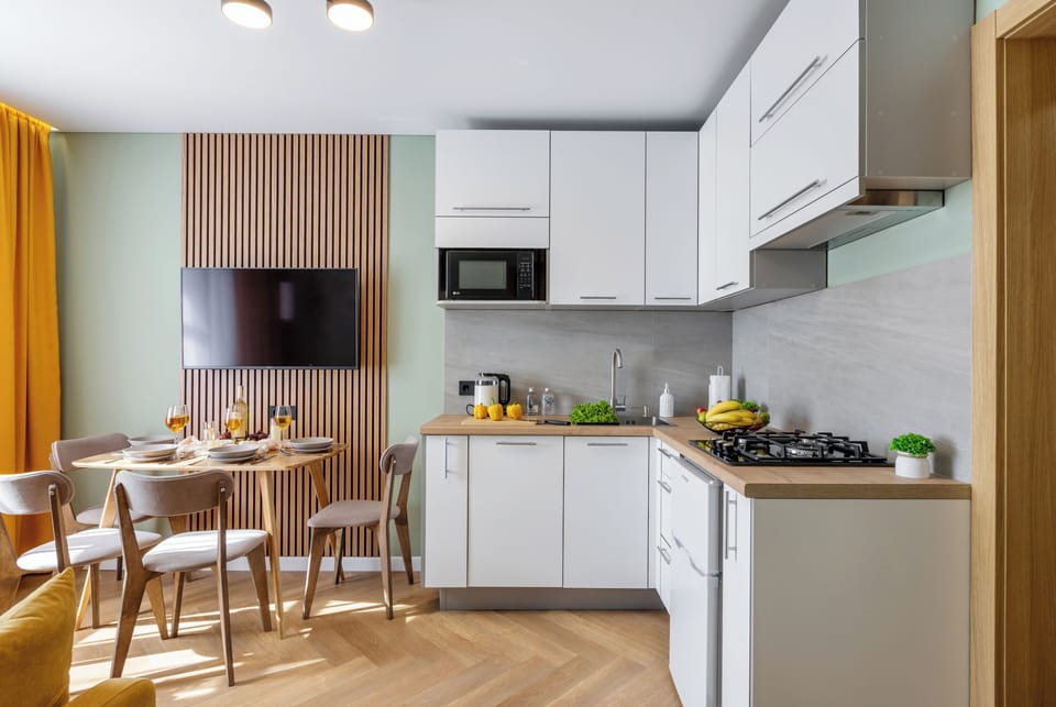 Superior Apartment, City View | Private kitchen | Griddle, cleaning supplies, paper towels, dining table