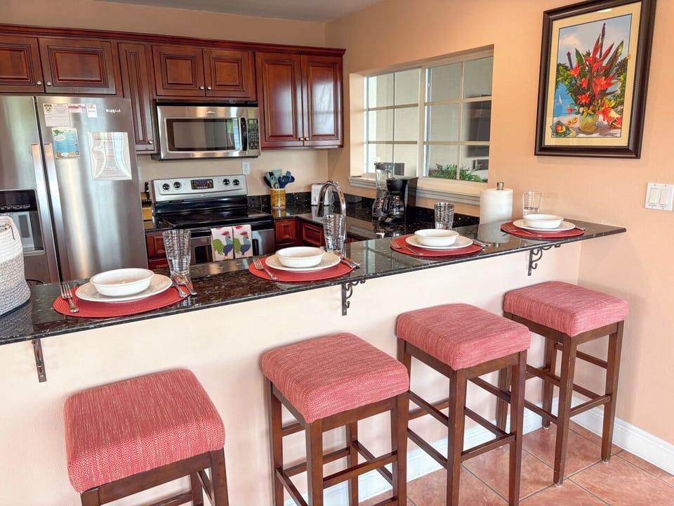 The kitchen includes 4 bar stools; a perfect spot for morning coffee 
