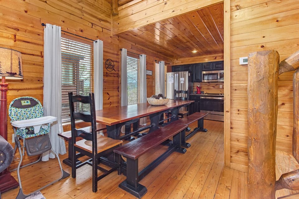 Gather around this rustic wooden dining table where family meals become cherished memories in your cozy cabin retreat.