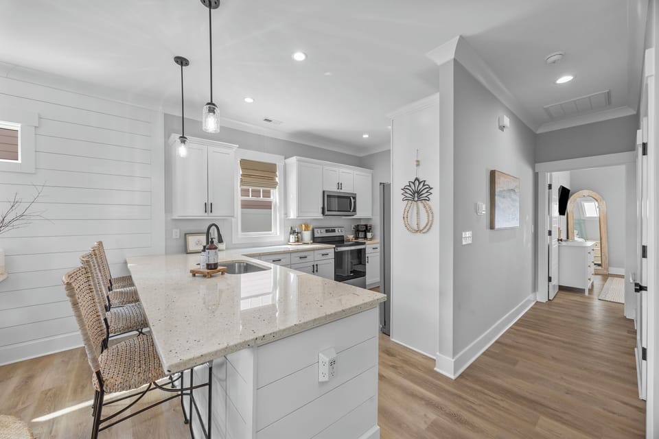 Bright and welcoming living spaces designed for relaxing, gathering, and making memories after days spent at the beach.