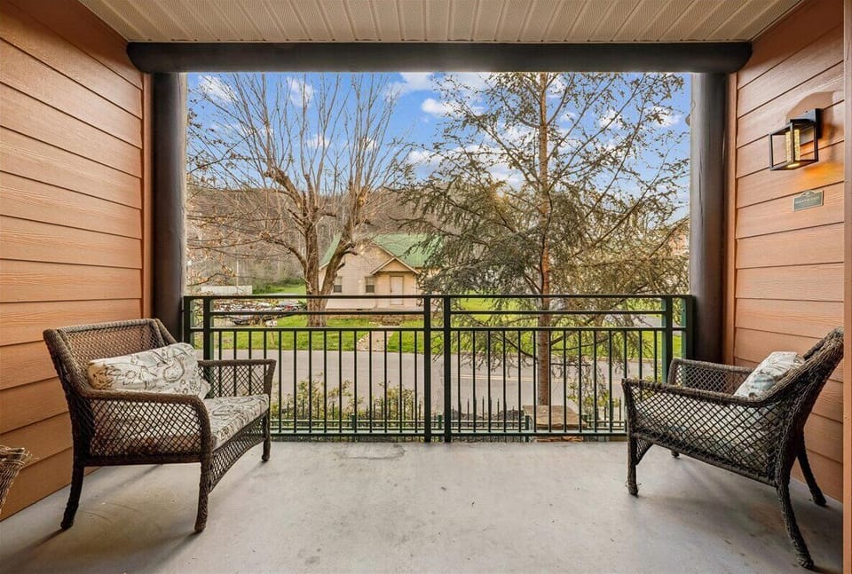 Unwind on your private covered balcony with cozy wicker seating, where you can sip your morning coffee while enjoying peaceful neighborhood views.