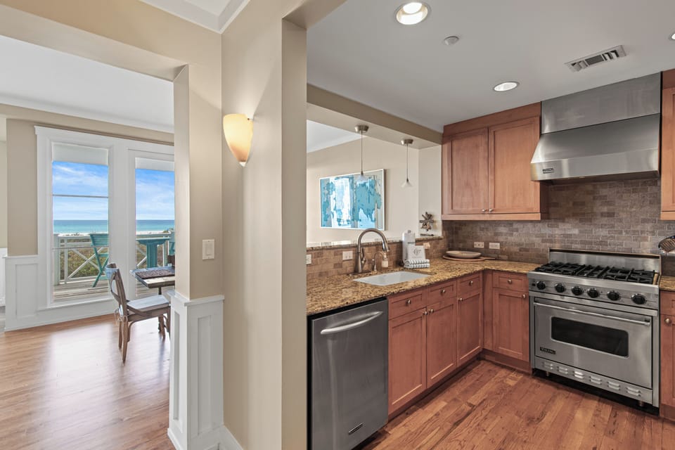 Your fully equipped kitchen opens to a dining area with stunning ocean views, perfect for preparing meals while enjoying the coastal scenery.