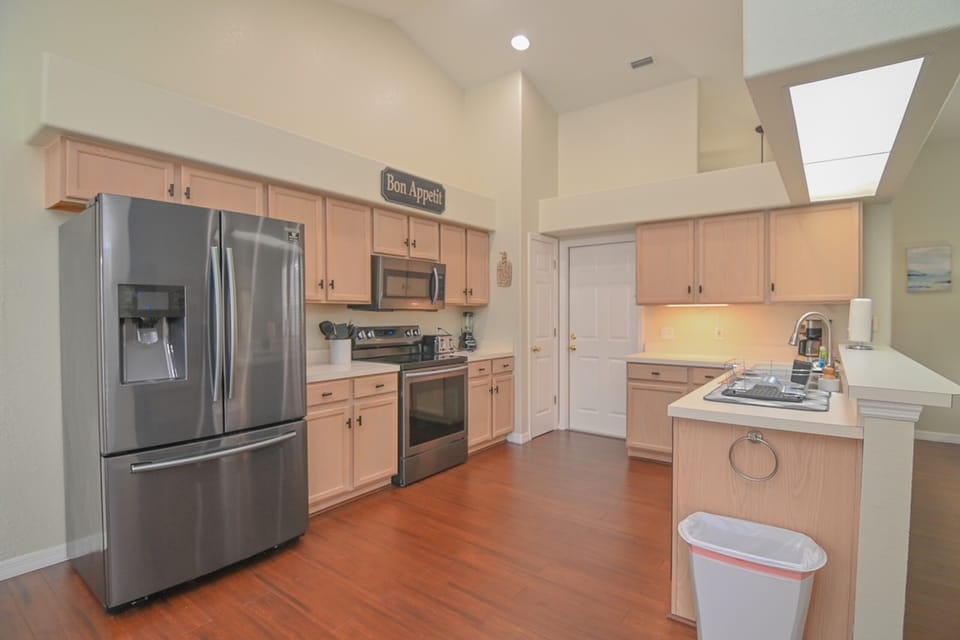 KITCHEN:  Fully Equipped Kitchen with Side-by-Side Refrigerator, Microwave, Electric Stove & Oven and Dishwasher