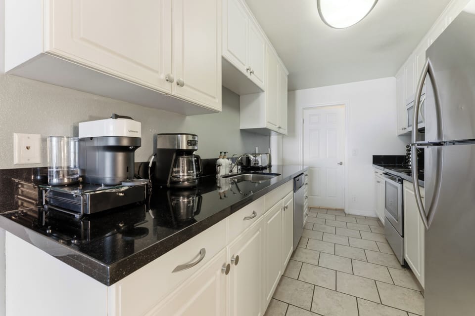 Bright, open-concept kitchen featuring sleek finishes and updated appliances.