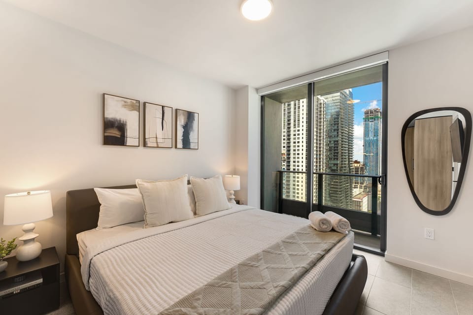 Peaceful bedroom with fresh linens and balcony views