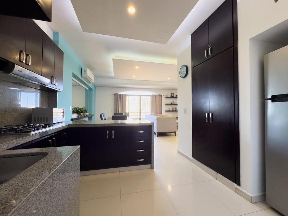 Modern kitchen with sleek cabinetry and open living area