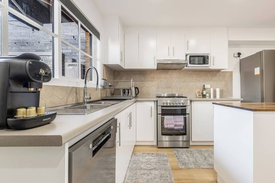 Whip up delicious meals in the modern kitchen, fully equipped with an oven, dishwasher, microwave, and a full-sized fridge.