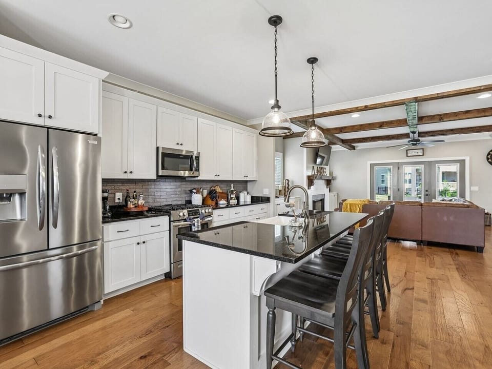 Kitchen area with island and bar stools