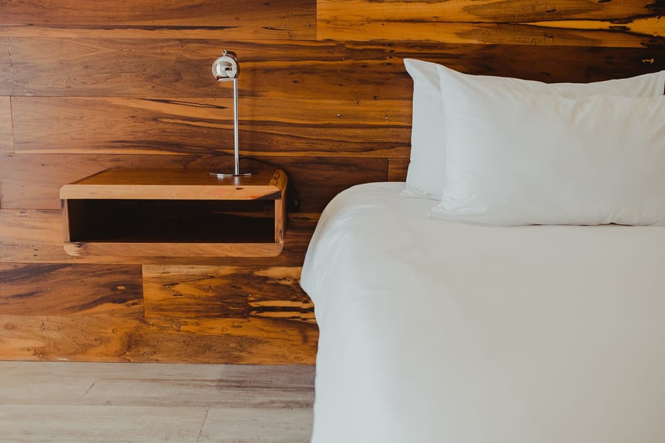 Settle in with bedside lighting and handcrafted wood details.