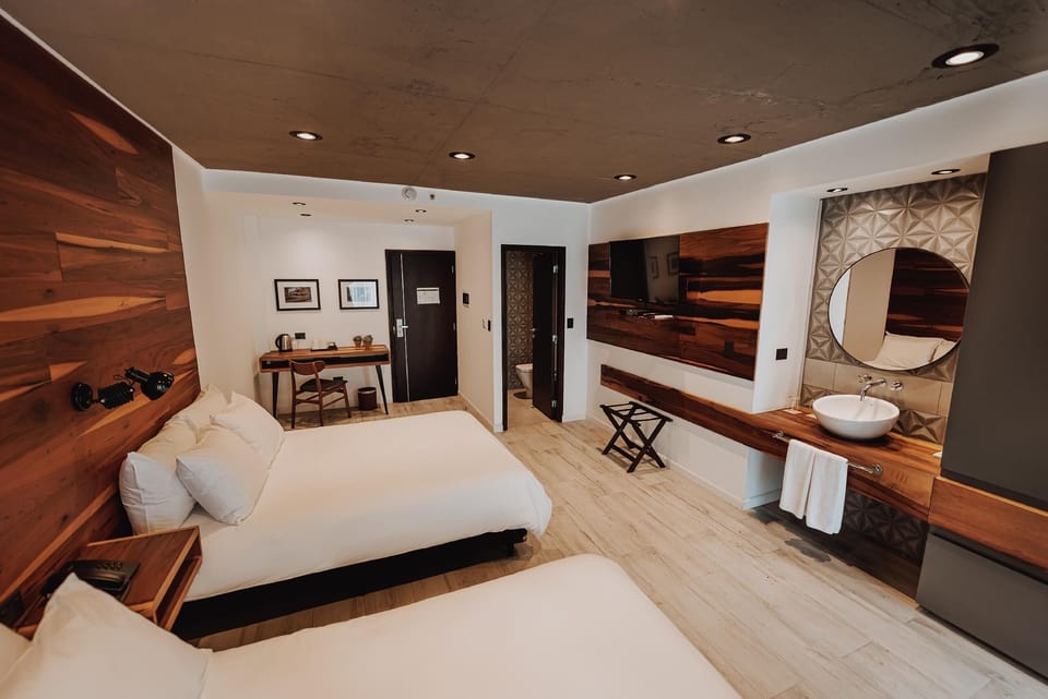 Refresh in a chic suite with warm wood accents.