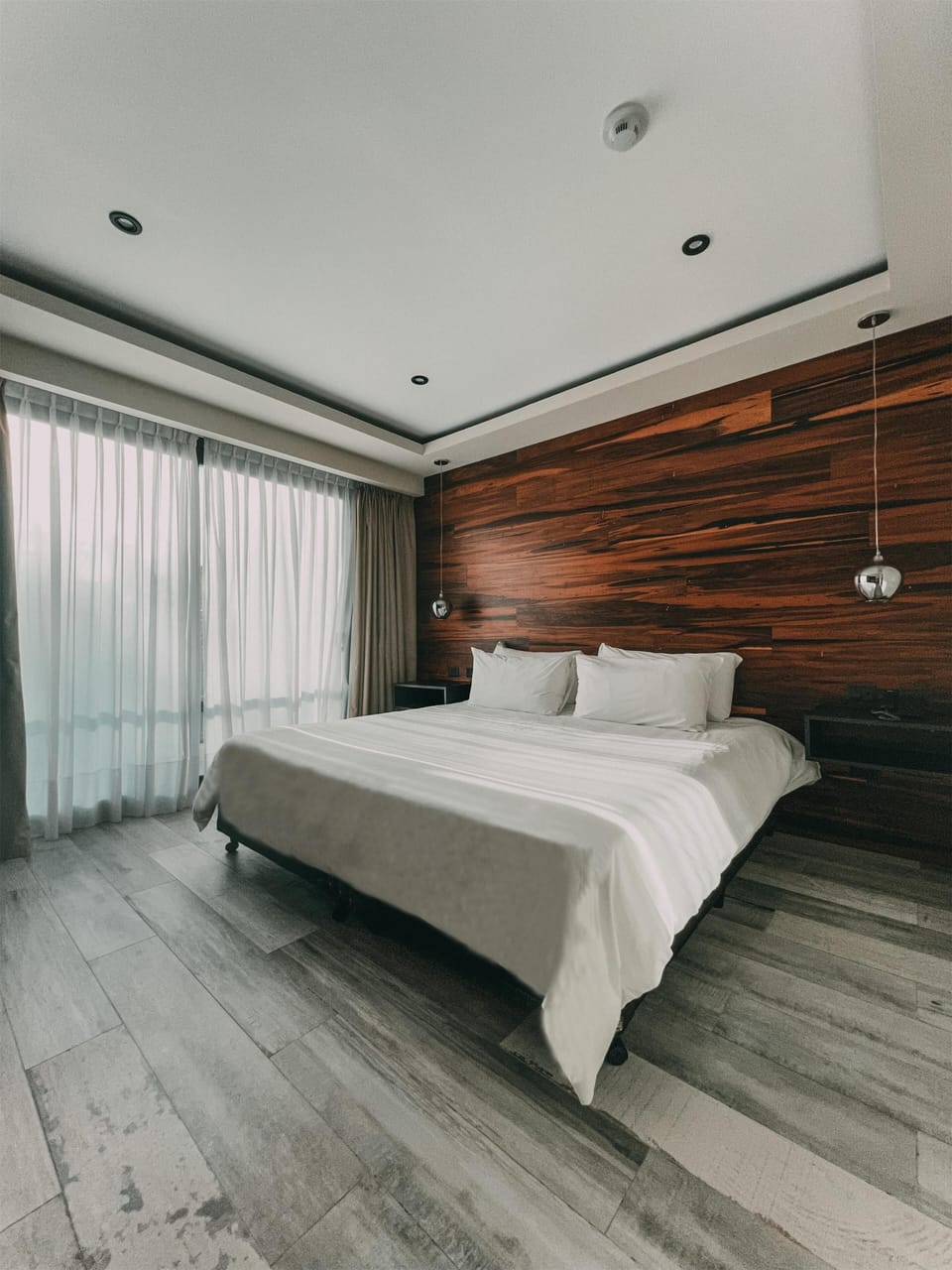 Unwind in a serene king bed with soft daylight.