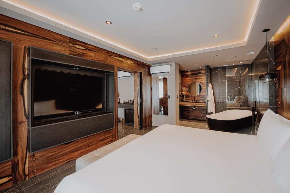 Lounge in bed with a big-screen view and luxe finishes.