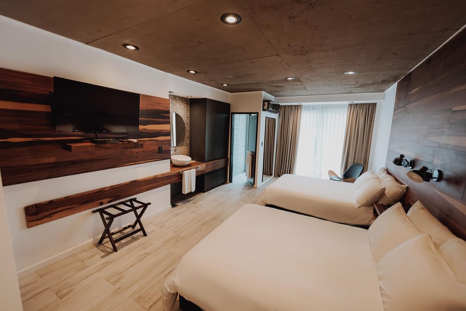 Unwind in a bright, modern room with plush beds.