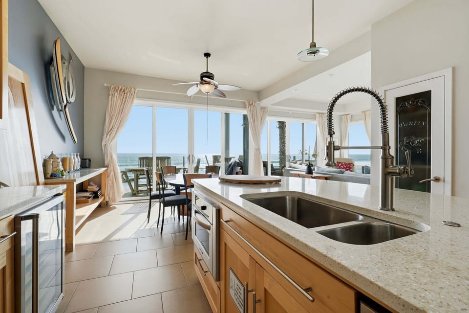 Spacious kitchen with bar seating and coastal views