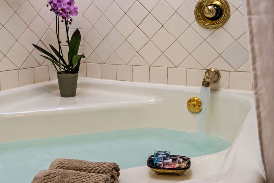 Napolian Stone Room | Bathroom amenities | Designer toiletries, hair dryer, towels, soap