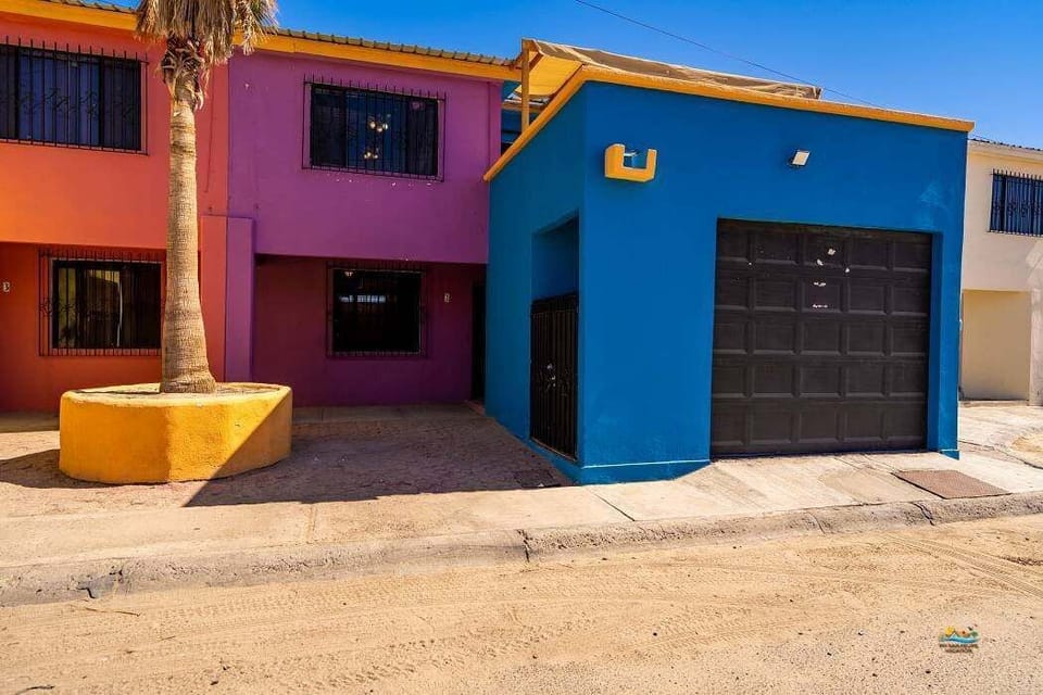 This side view shows the outdoor stairwell leading to secure garage parking — just steps from the beach and 2 blocks from the Malecon .