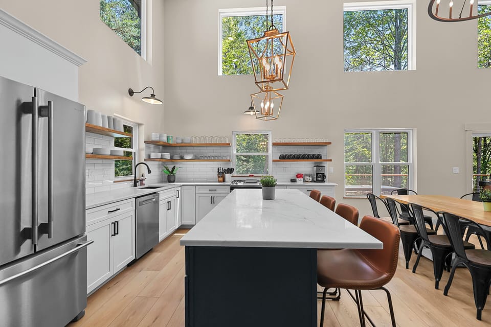 The kitchen is fully stocked with essential cooking items, stainless steel refrigerator, dishwasher, gas double stove, microwave, and garbage disposal. 