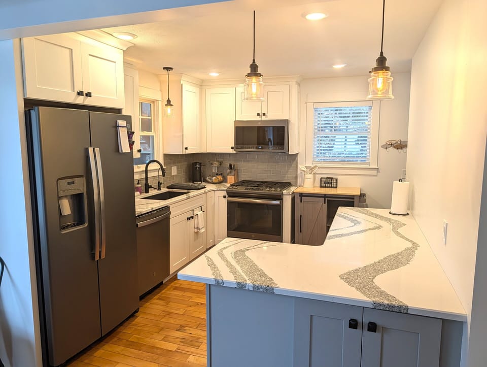 KITCHEN (MAIN FLOOR):  Fully-functional modern kitchen with newer appliances including a dishwasher and a gas range.