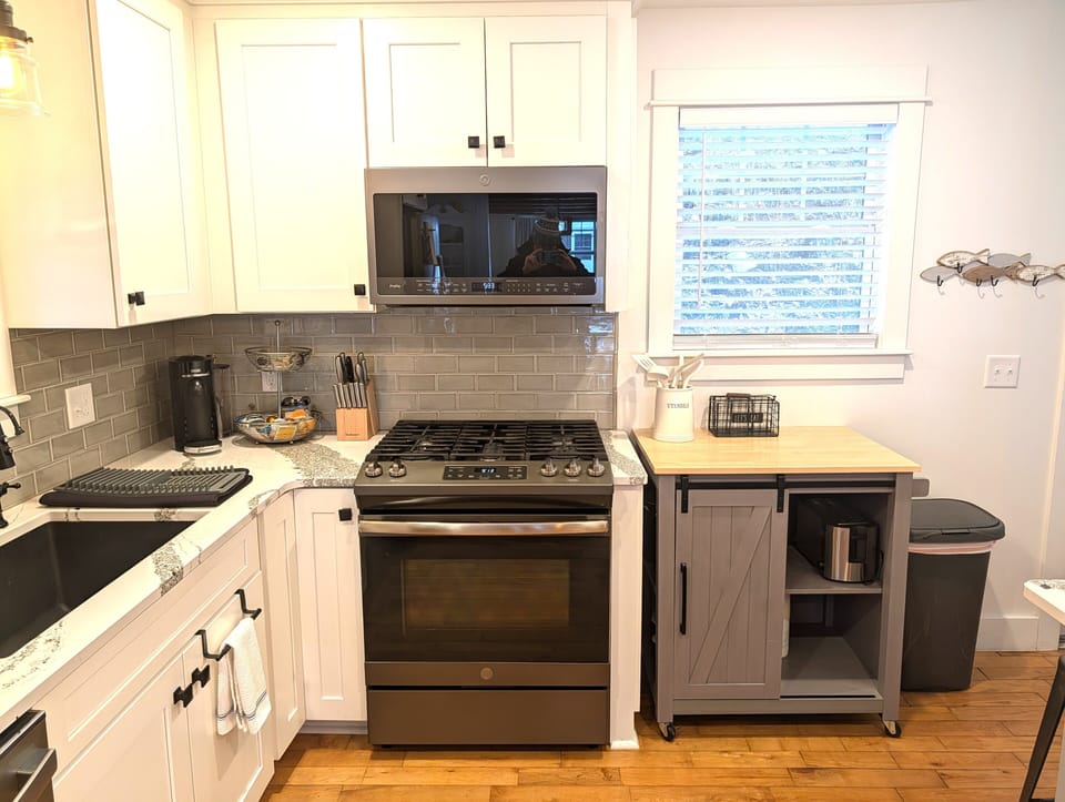 KITCHEN (MAIN FLOOR):  Fully-functional modern kitchen with newer appliances including a dishwasher and a gas range.
