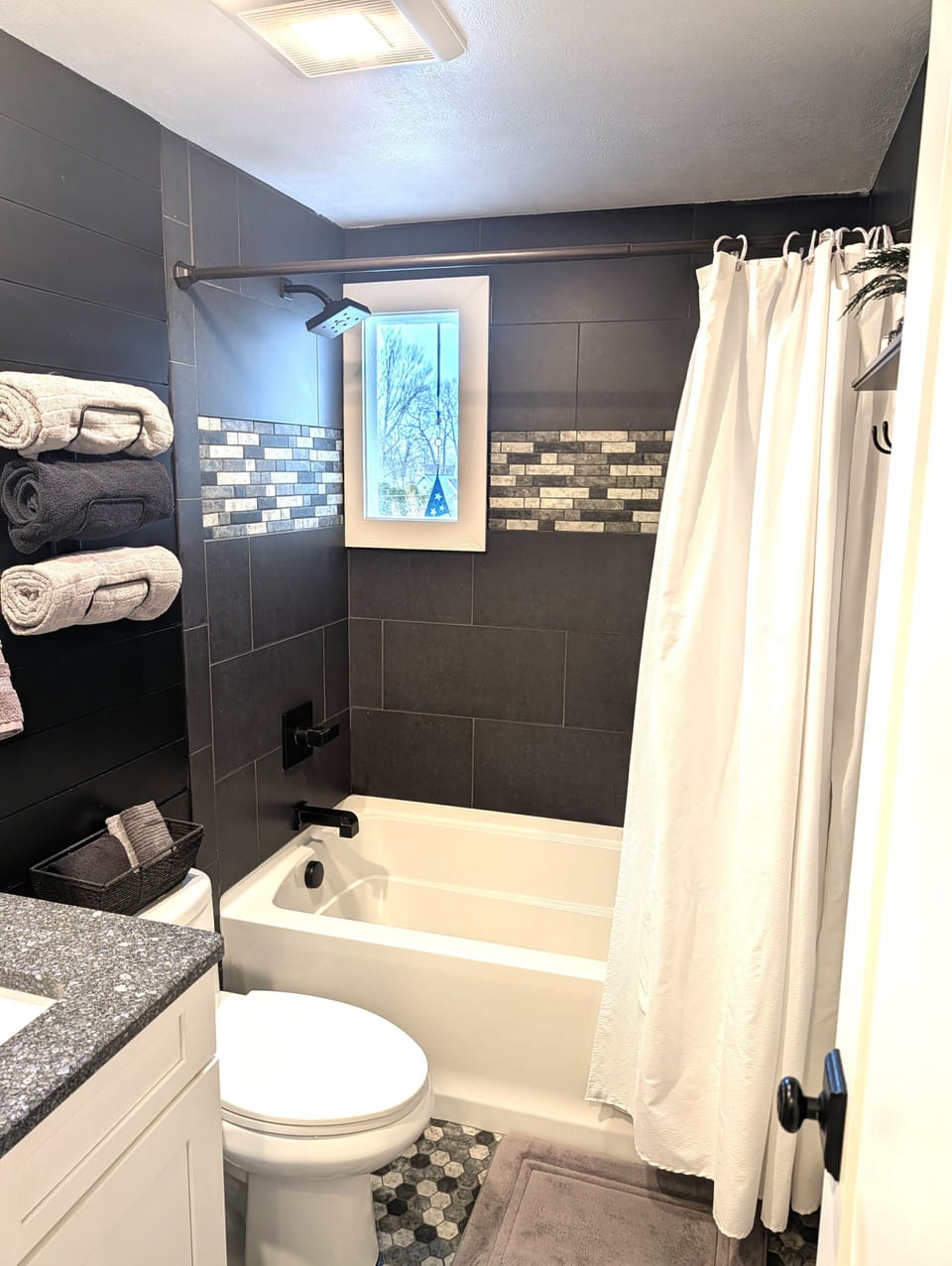 BATHROOM #1 (MAIN FLOOR):  Full bathroom on the main floor with a combination tub and shower.