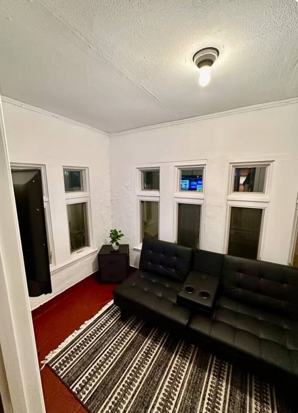 Cozy living room featuring a charming fireplace as the focal point, perfect for relaxing evenings. Warm lighting, comfortable seating, and inviting decor create a welcoming space for gathering and unwinding.