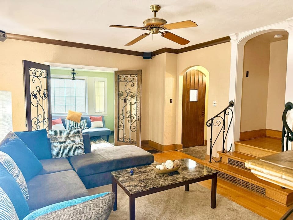 Cozy living room featuring a charming fireplace as the focal point, perfect for relaxing evenings. Warm lighting, comfortable seating, and inviting decor create a welcoming space for gathering and unwinding.