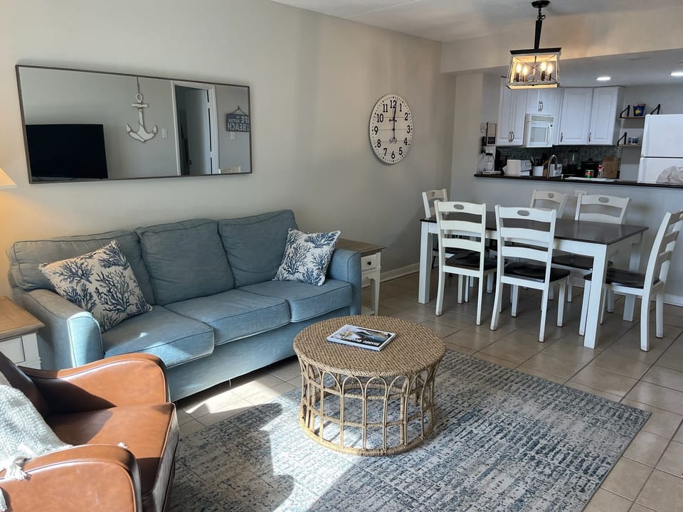 Comfortable living room with direct ocean views and easy access to your private balcony.