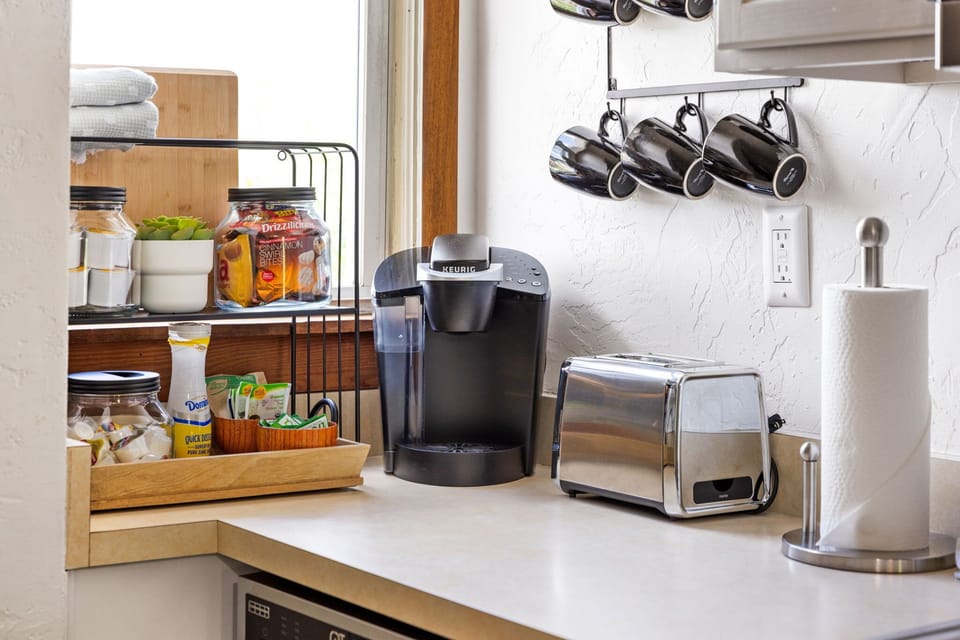 Enjoy a clean, organized kitchen setup with essentials and a convenient coffee station within reach. Thoughtfully arranged for ease and comfort, making your daily routine simple and enjoyable.