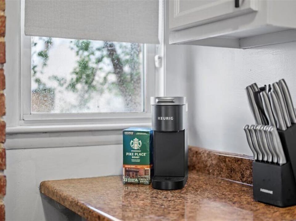 Bright kitchen coffee station with Keurig and stocked coffee pods