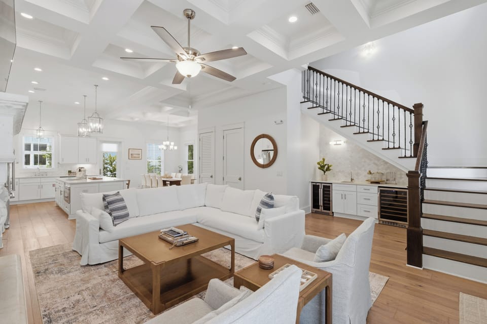 Relax in your elegant living space with soaring coffered ceilings, plush seating, and seamless flow to the gourmet kitchen.