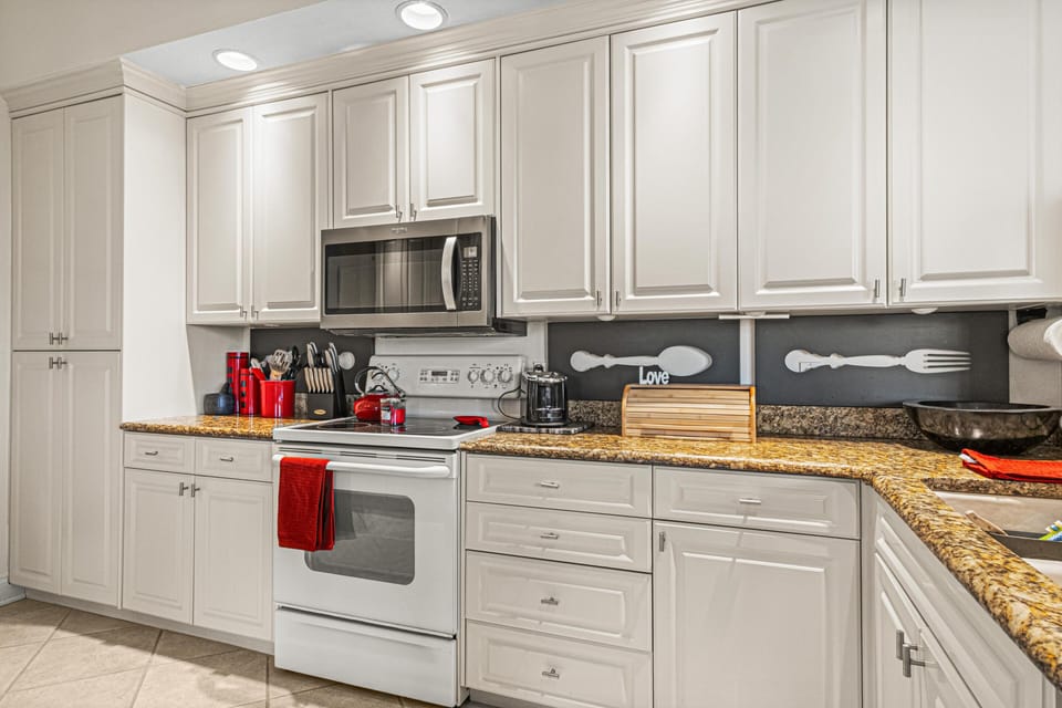 Bright, modern kitchen with ample storage and granite countertops