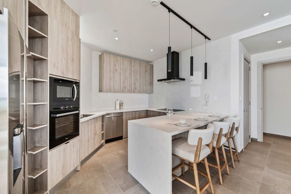 Spacious kitchen with bar seating and clean modern finishes