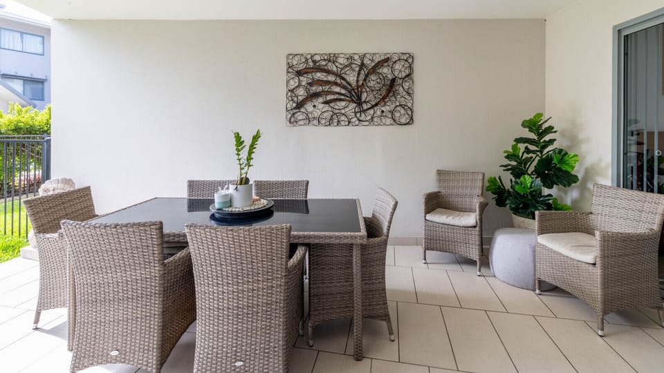 Relax-and-eat terrace area featuring cushioned wicker chairs and an inviting, low-key layout for groups.